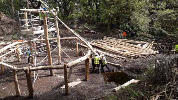 The first Roof Beam being man-handled into position.