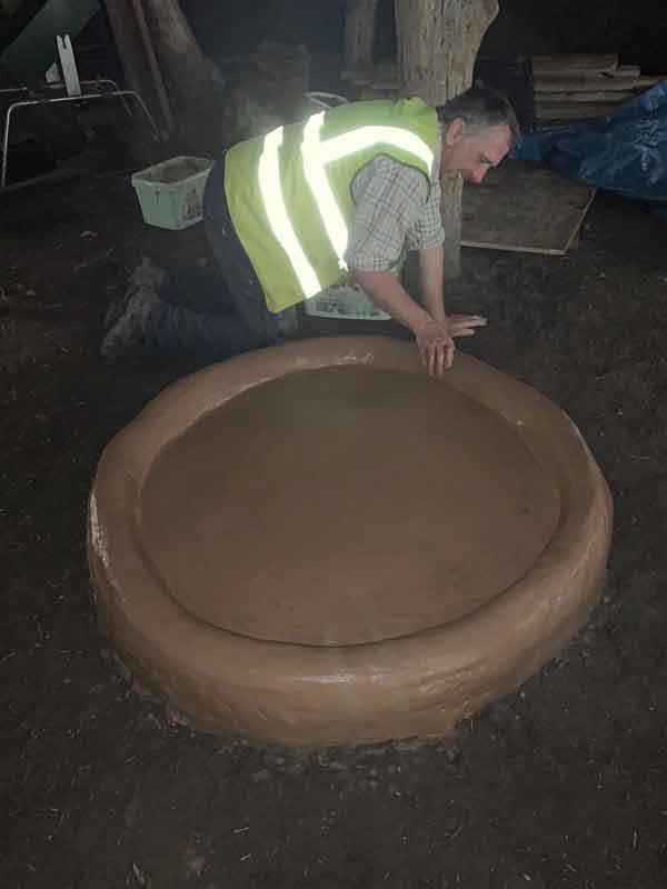 John making the hearth for the Roundhouse.