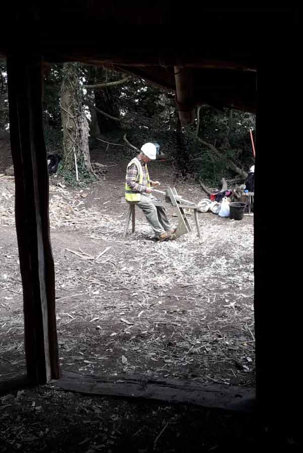 Edwin making pegs to secure the mortice and tenon joints of the door frames.